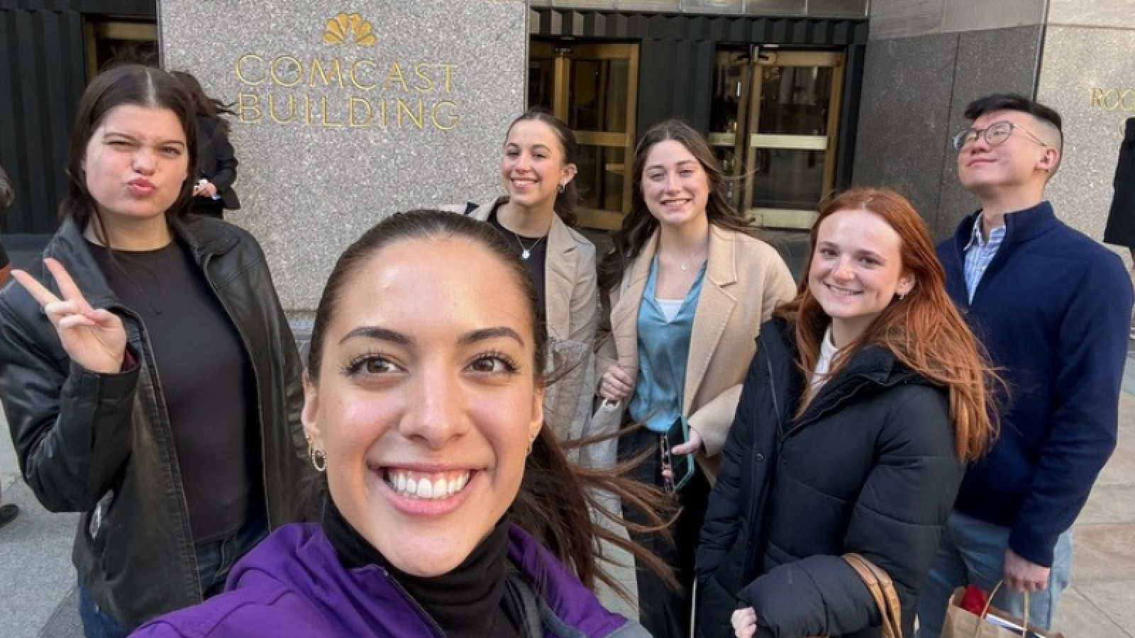 PRSSA Chapter president Isa Rentería takes selfie with PRSSA students outside of NBC 30 Rock.