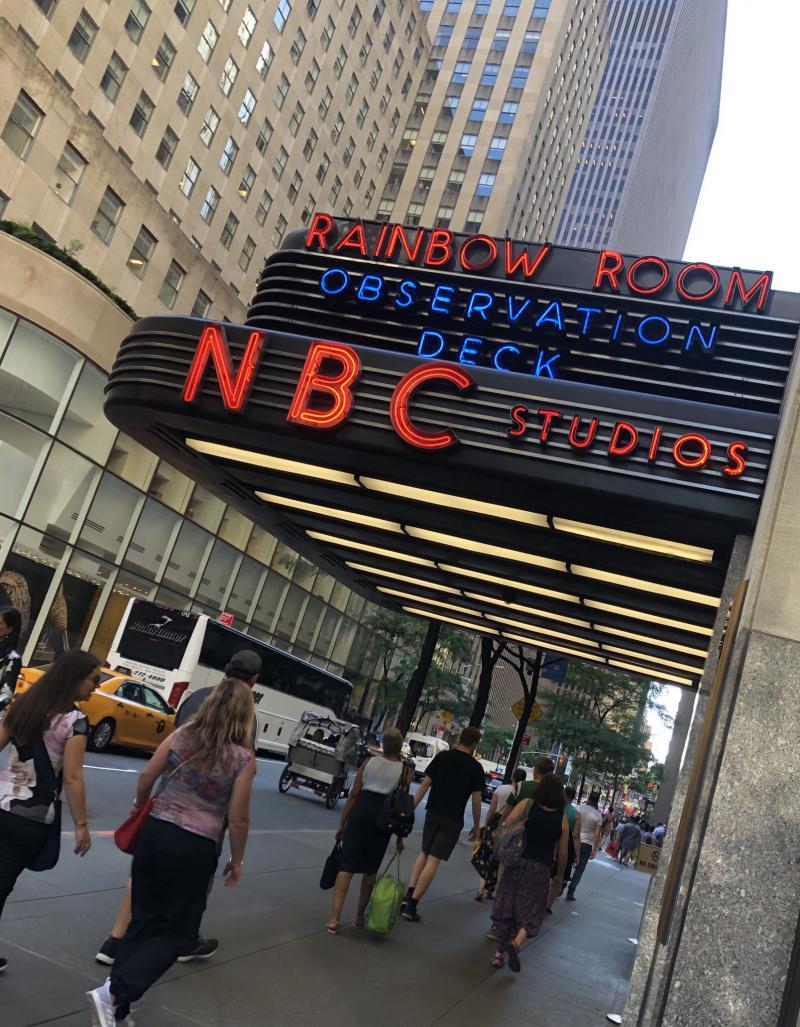 People walking by the building of NBC Studios in NYC