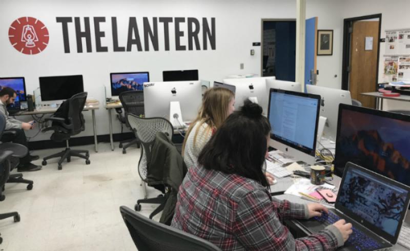 Students work in The Lantern newsroom
