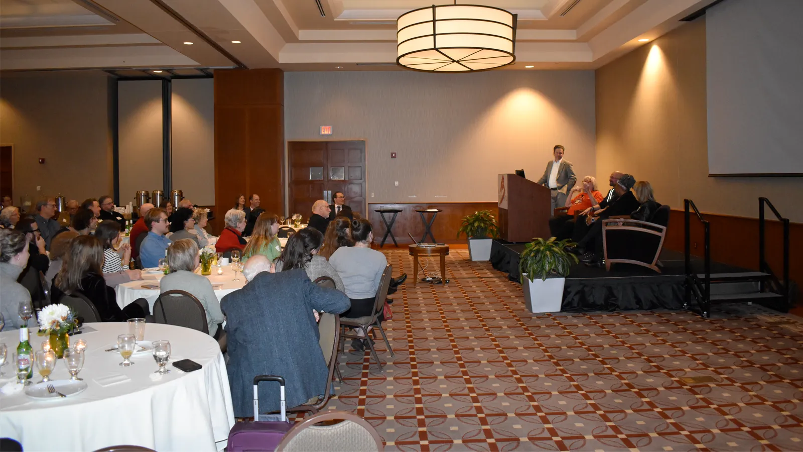 Guests and speaker at a dining hall for the Lantern reunion