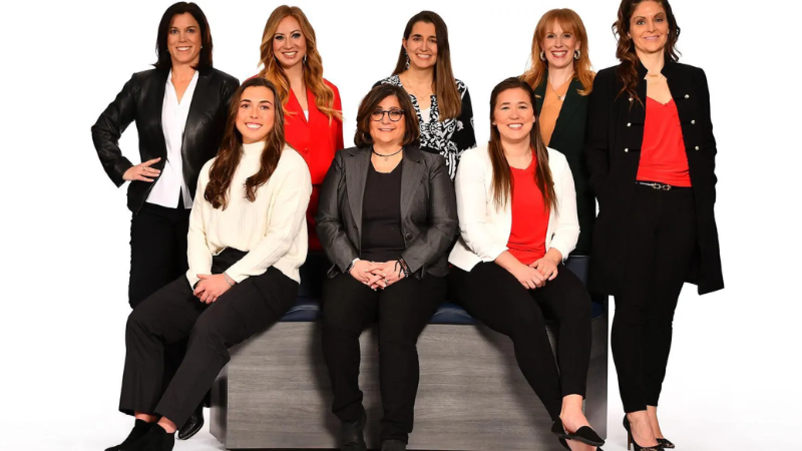 Group photo of eight women dressed professionally