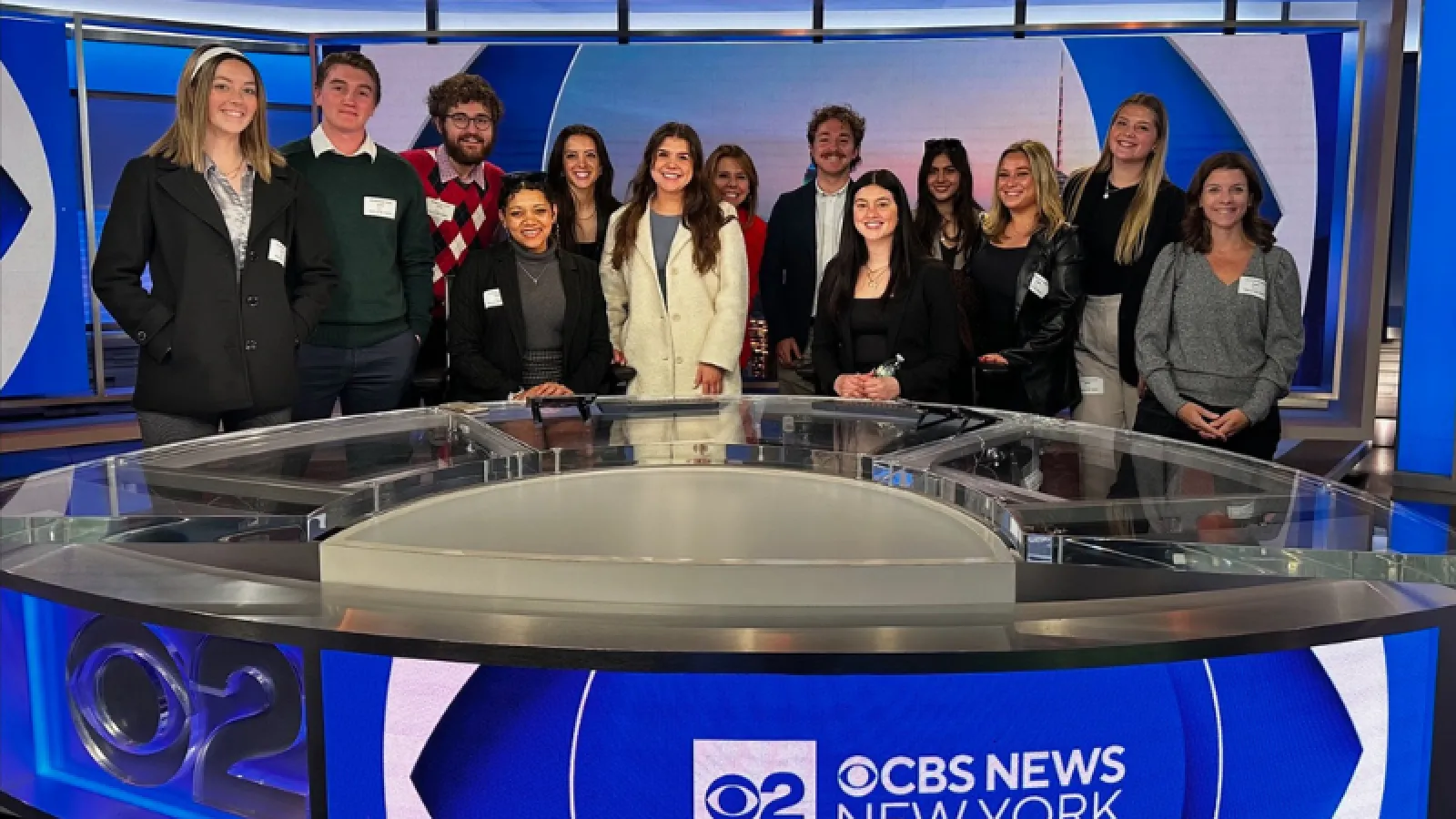PRSSA students pose for photo in a news studio at CBS.