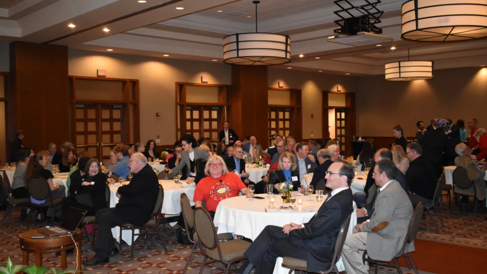 Alumni, faculty and students pictured sitting at round tables in a ballroom at the Blackwell Inn.