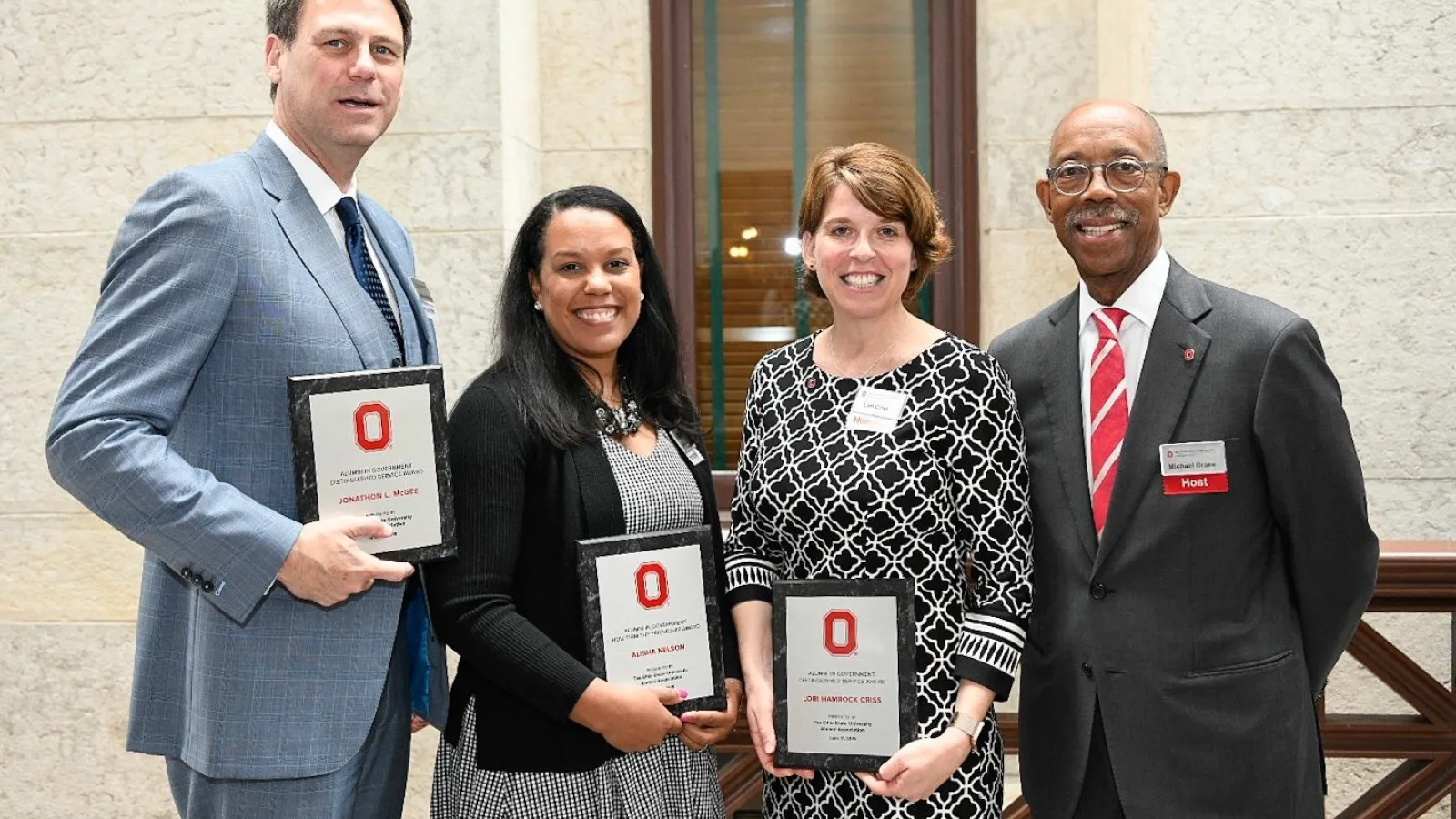 Alisha Nelson poses with Ohio State President Michael Drake and Distinguished Service Award Winners