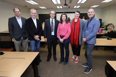 Mary Sterenberg accompanied by senior leadership after being surprised with award.