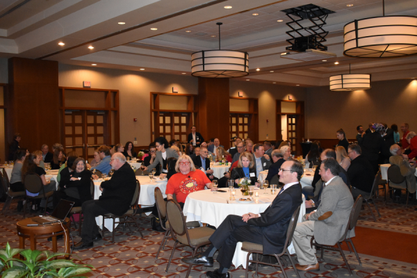 Alumni, faculty and students pictured sitting at round tables in a ballroom at the Blackwell Inn.