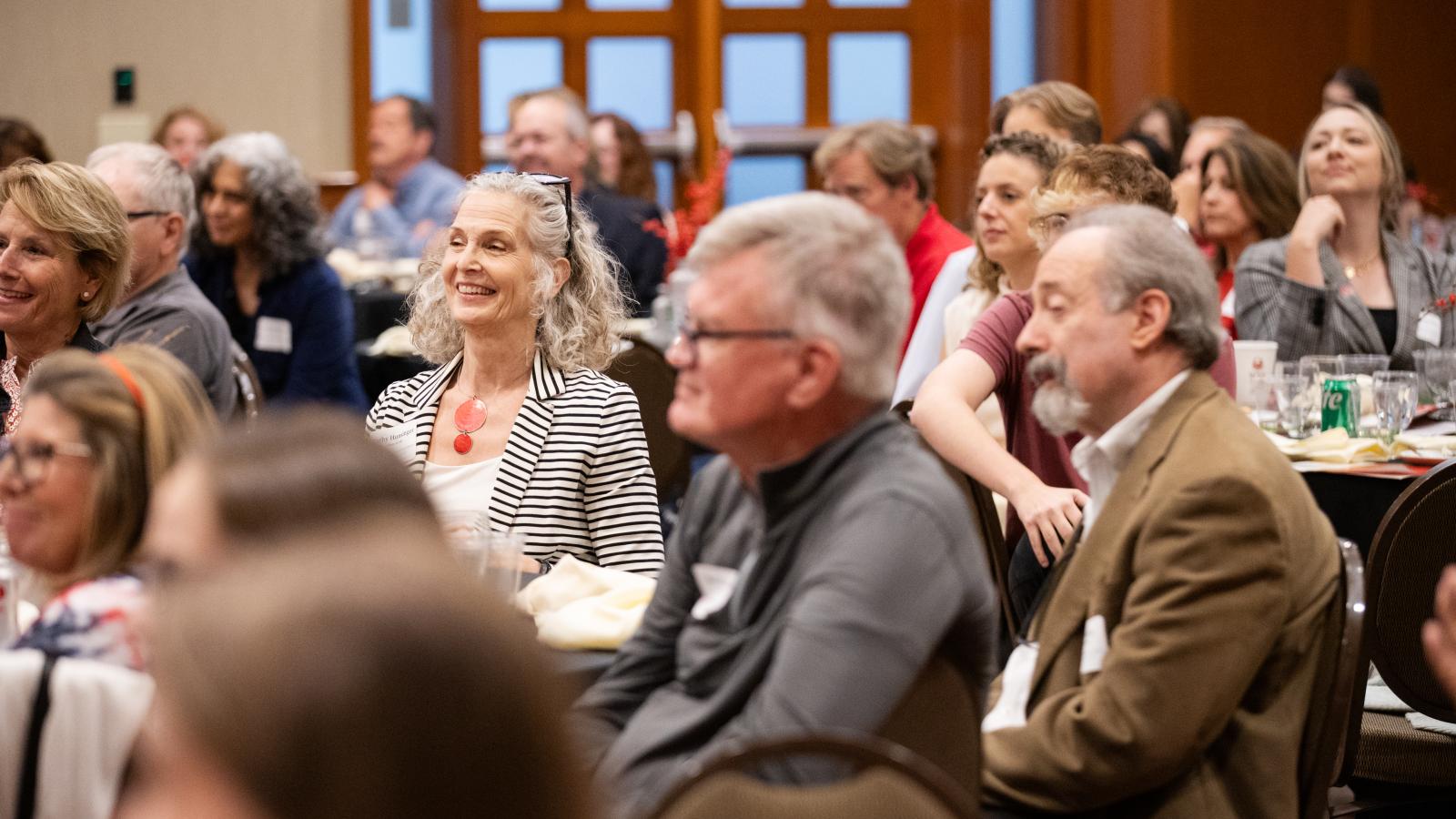 audience listening to speakers at alumni reunion