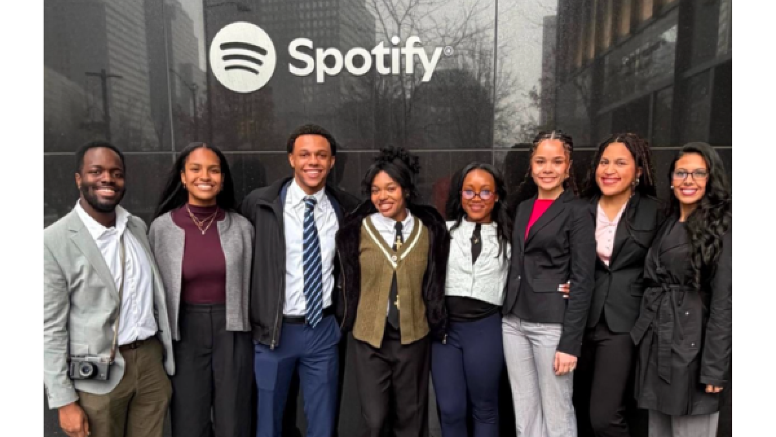 Students standing infront of spotify 